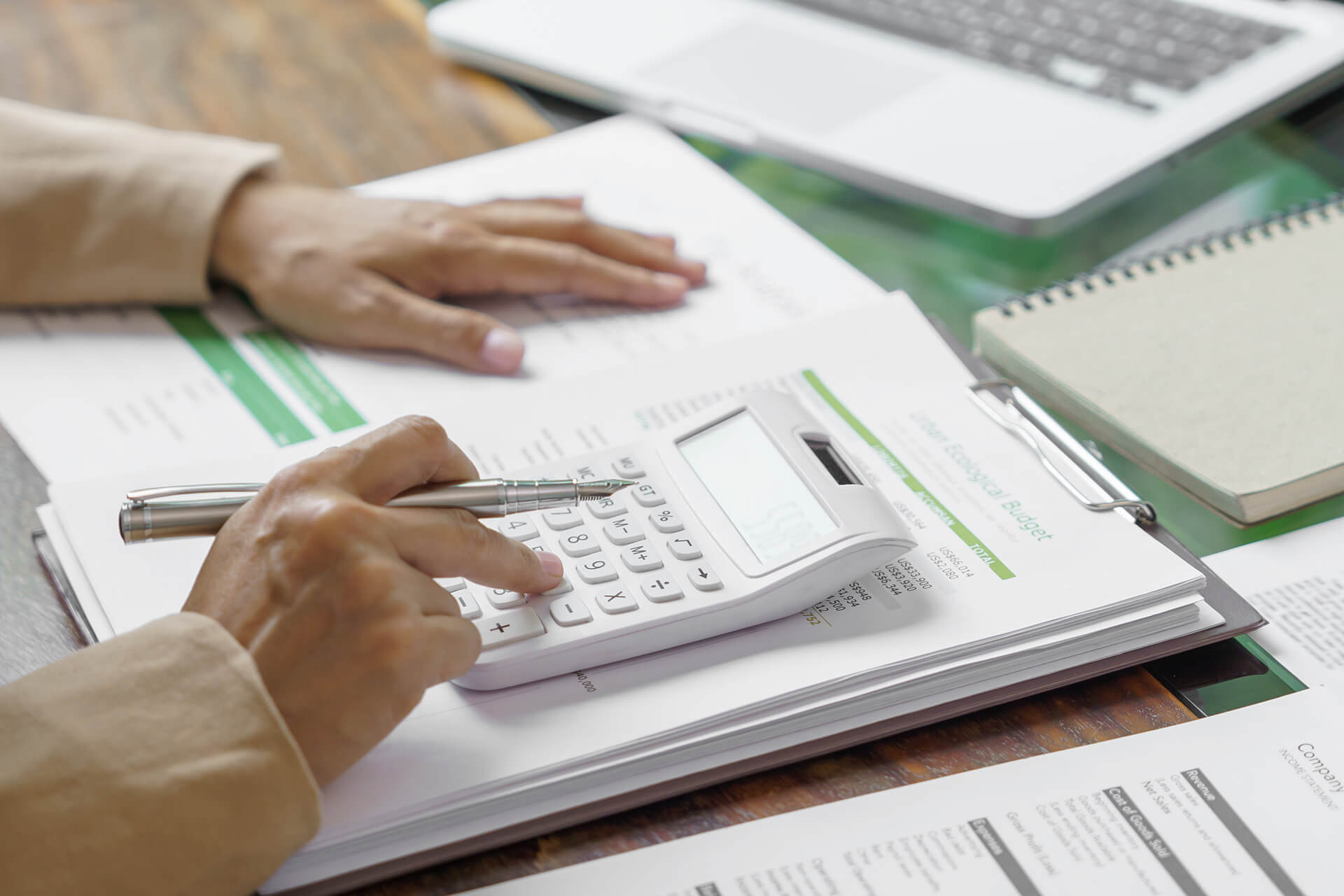 Accounting documents and a calculator on a desk